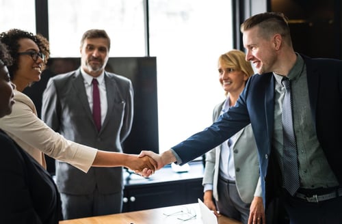 Image of woman and man shaking hands.