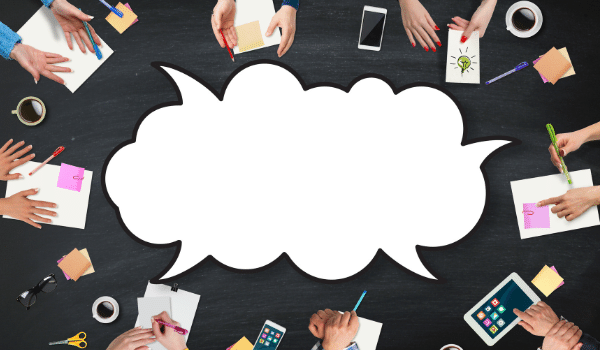 people sitting around the table with one large speech bubble in the middle