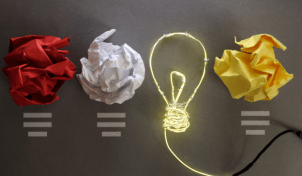 crumpled paper as a light bulb and a drawing of a lit light bulb