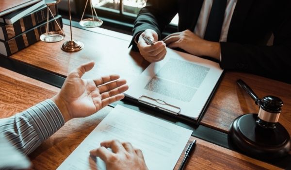 attorney and client at a desk with documents