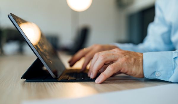 person typing on a laptop computer